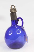 A Bristol Blue glass spirit decanter, having repousse decorated pewter lid and collar, h.22.5mc