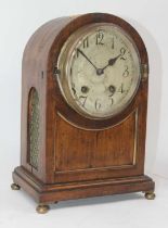 A mid-19th century mahogany cased dome topped mantel clock, the silvered dial showing Arabic markers