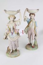 A pair of 20th century Italian bisque porcelain figures of lady and gentleman each shown standing in