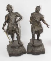 A pair of early 20th century spelter figures of warriors, each shown standing on stepped plinth,