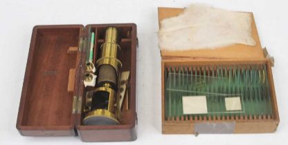 A vintage brass student's monocular mircoscope, cased; together with a collection of microscope