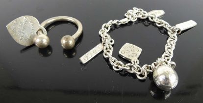 A white metal dog ring, stamped Tiffany & Co; together with a white metal bracelet with Tiffany & Co
