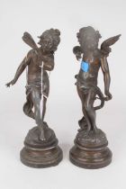 A pair of spelter figures of cherubs, each shown standing on naturalistic base and further socle