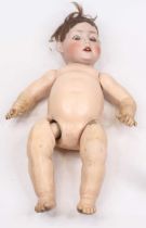 A vintage Simon Halbig bisque porcelain headed doll, having rolling glass eyes and two upper teeth