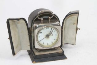 An early 20th century chromed metal carriage clock, the enamelled dial showing arabic markers, h.