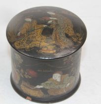 A Japanese black lacquered and gilt decorated cylindrical box, h. 7.5cm