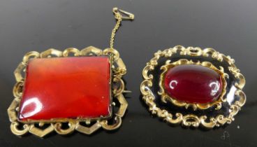 A Victorian black onyx, ruby glass set, and pinchbeck backed brooch, 4cm; together with a