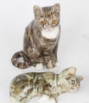 A Winstanley pottery cat, modelled seated, having yellow glass eyes, h.21cm; together with