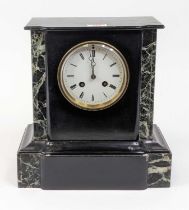 A Victorian black slate mantel clock, having an enamelled dial showing Roman numeral markers and