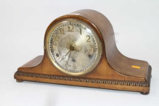 An early 20th century walnut cased mantel clock, the brushed metal dial with applied Arabic markers,