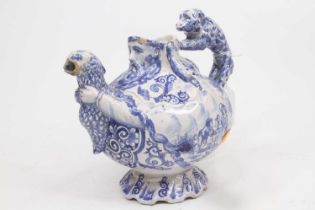 An 18th century Delft blue and white teapot, in the form of a bearded gentleman holding a bird and