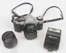 A Canon AE1 SLR camera; together with various accessories