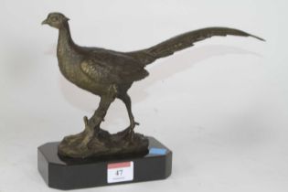 A bronzed metal model of a pheasant, shown standing on naturalistic base, mounted to further