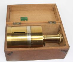 A circa 1900 lacquered brass cased surveyor's compass, of drum shape, with engraved outer scale,