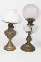 A Victorian oil lamp, having a frosted glass shade over brass burner, clear glass reservoir on