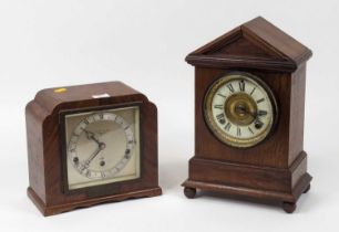 A late 19th century American walnut cased mantel clock, of architectural form, the enamelled chapter