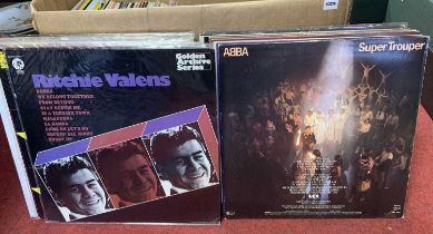 A collection of vintage 12" vinyl records, to include ABBA Super Trooper, The Buddy Holly Story, and