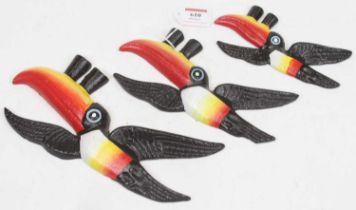 A graduated set of three reproduction cast iron Guinness advertising toucans