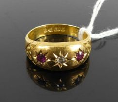 An 18ct gold, ruby and diamond ring, arranged as three 'gypsy' set round cut stones, 2.9g, size O