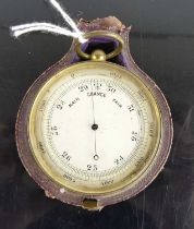 A brass cased pocket barometer, having unsigned silvered dial, dia.48, in leather travel case