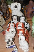 A collection of Staffordshire pottery spaniels, to include a pair of black and white decorated