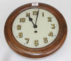 An early 20th century beech wall clock, the painted glass dial showing Arabic numerals, dia.28cm