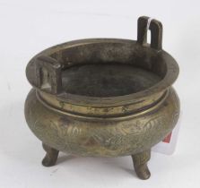 A Chinese brass tripod censer, decorated with a phoenix, dia.12cm In our opinion this is a copy,