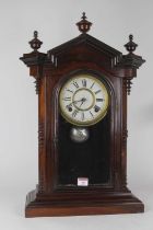 A late 19th century American simulated rosewood mantel clock, the painted metal dial having Roman