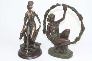A bronzed resin figure of a nude woman beneath an arch of fruiting vines, h.33cml together with