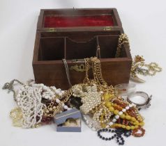 A George III mahogany tea caddy, containing a collection of beaded necklaces