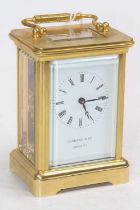 A Garrard & Co brass carriage clock, the enamelled dial showing Roman numerals, having visible