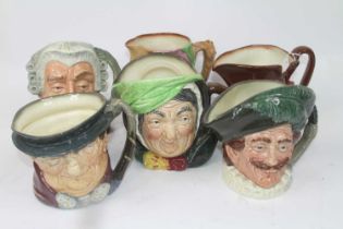 A collection of six Royal Doulton character jugs, to include The Lawyer, The Jester, and Scrooge