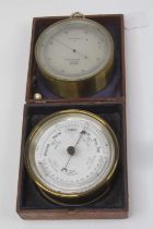 A late 19th century lacquered brass cased aneroid barometer, the brushed metal dial with outer