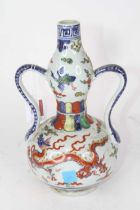 A Chinese porcelain vase, of twin handled double gourd form, painted with five-claw dragon amongst