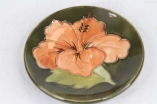 A Moorcroft pottery dish, tube-line decorated in the Hibiscus pattern, dia.11.5cm