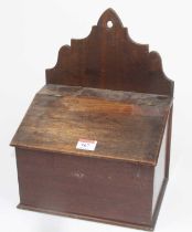 A 19th century provincial mahogany and walnut candle box, having a shaped back with hanging loop