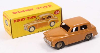 A Dinky Toys No. 154/40F Hillman Minx saloon comprising butterscotch body with cream hubs in the