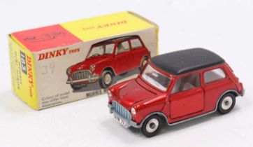 A Dinky Toys No. 183 Morris Mini Minor comprising red body and black roof, with silver spun hubs,