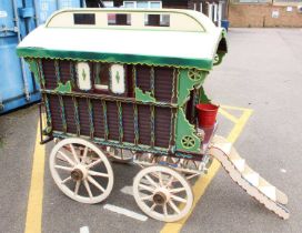 A very well made model of a approximately quarter scale travelling caravan, finished in cream, green