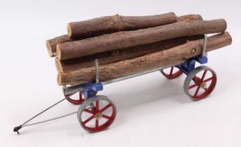 An original Mamod log trailer with original load and blue chassis and red spoke wheels