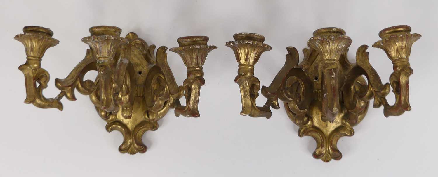 A pair of carved gilt wood three branch wall sconces, each height 19cm Probably early 20th