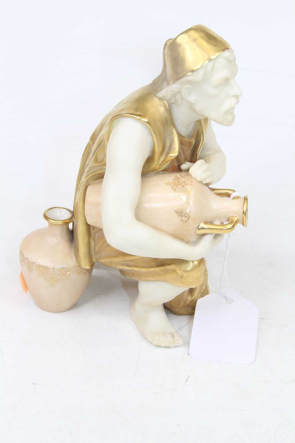 A Royal Worcester figure of a water-carrier, heightened in gilt, h.16cm - Image 2 of 2