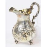 A Victorian silver cream jug, of baluster shape, having scrolled acanthus handle and floral repousse