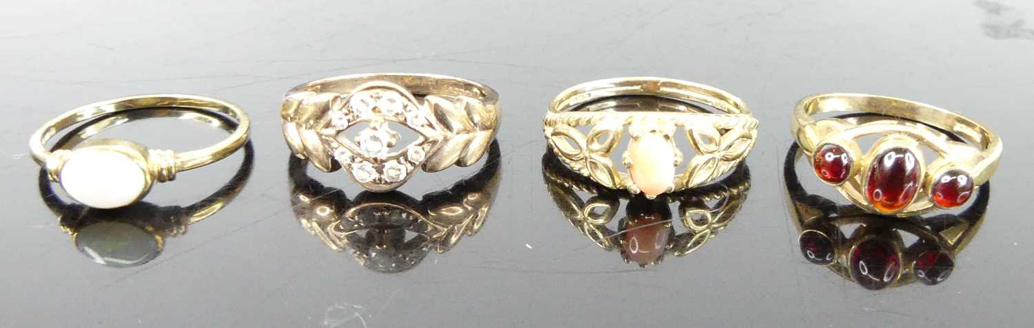 Four various 9ct gold dress rings, comprising coral, opal, garnet three-stone and white hardstone