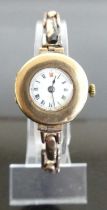 A lady's vintage 9ct gold cased manual wind wristwatch, on yellow metal expanding link bracelet,