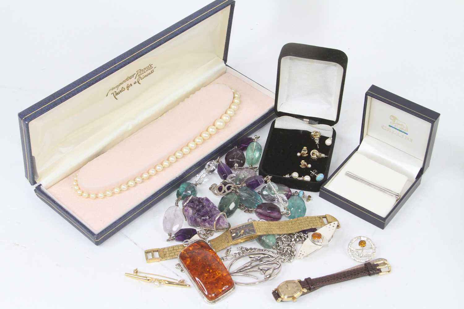 A collection of costume jewellery to include beaded necklaces, brooches, and earrings