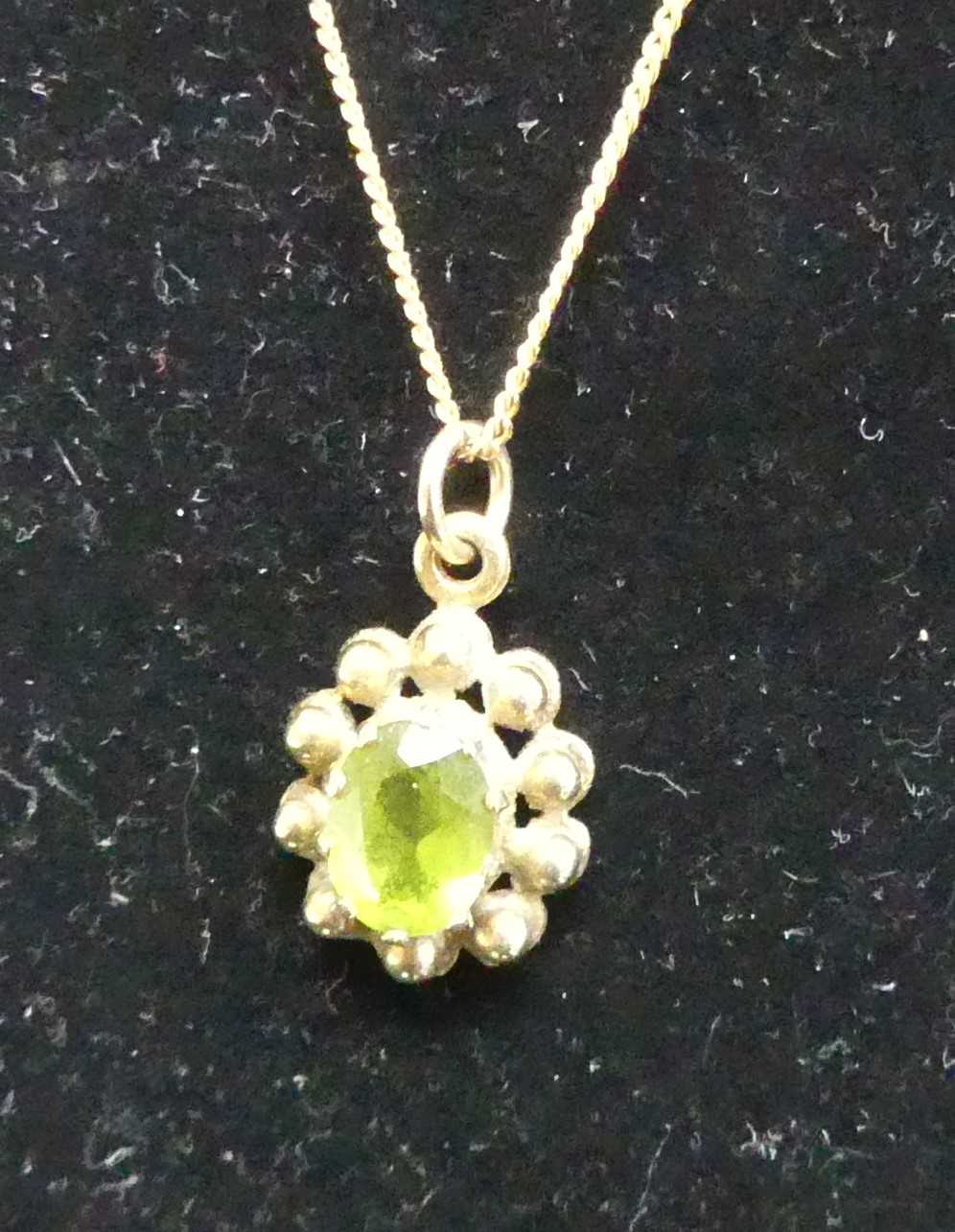 A yellow metal and green peridot set pendant on 9ct gold finelink neck chain, 3.4g; together with - Image 2 of 2
