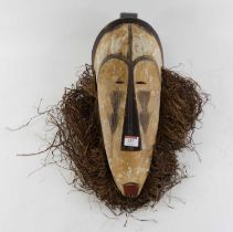 A West African carved wood Ngil judicial mask, Fang people, Gabon, height 52cm with certificate