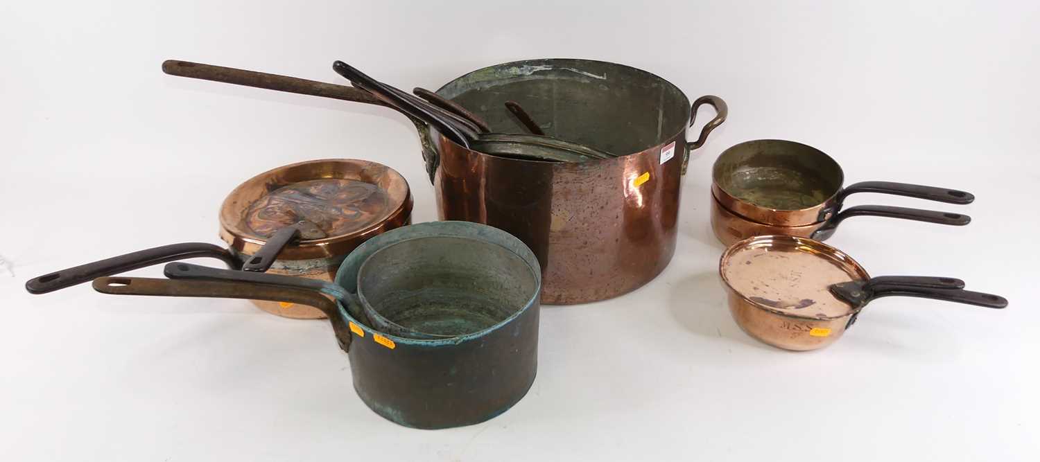 A large 19th century copper saucepan having riveted wrought iron handle, dia. 36cm, together with