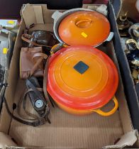A Le Creuset orange enamelled pot, together with another similar, and three vintage cameras